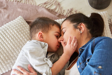 Little boy tenderly cuddles with his mother