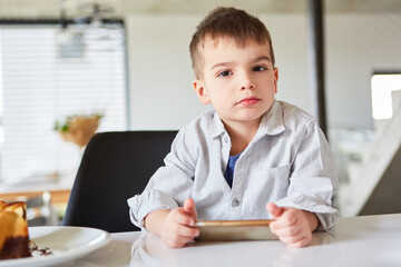 Little boy at the table with a tablet pc
