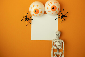 toy eyes on an orange background with a place for text, halloween concept