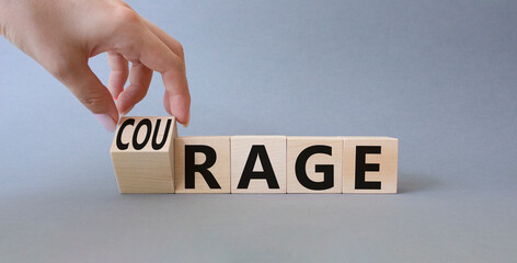Courage and rage symbol. Businessman hand turnes wooden cubes and changes word Rage to Courage....