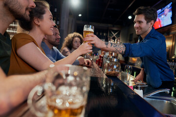 Caucasian of male bartender serving beer at bar