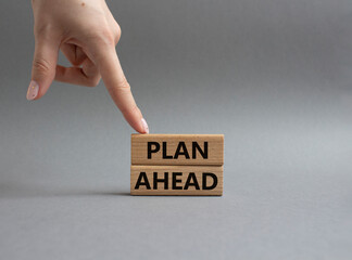 Plan ahead symbol. Wooden blocks with words Plan ahead. Beautiful grey background. Businessman hand. Business and 'Plan ahead' concept. Copy space.