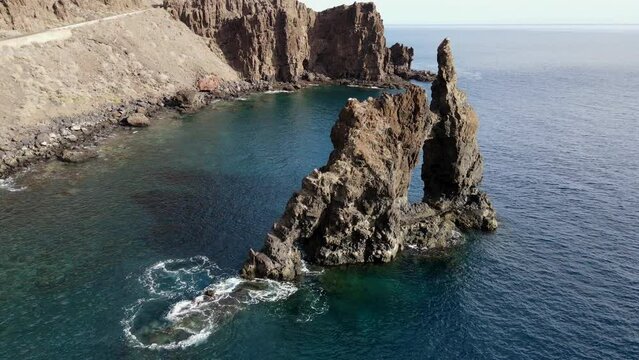 aerial shot in orbit over the Roque de la Bonanza on the island of El Hierro on a sunny day, Canary Islands.