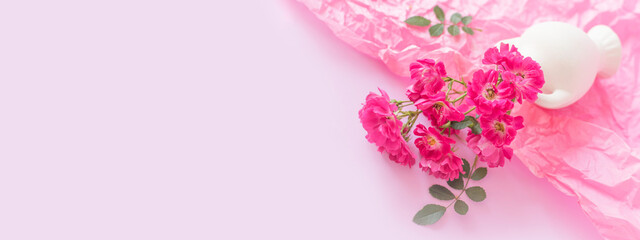 Pink roses in a white vase. Festive Pastel pink background.Floral card,selective focus, toned, copy space.Banner