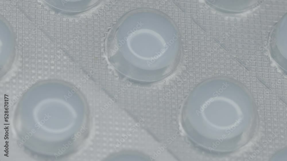 Poster white pills in a blister are rotated in a circle