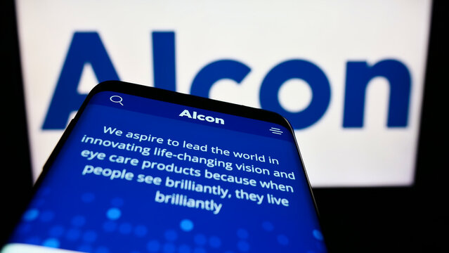 Stuttgart, Germany - 08-28-2022: Mobile phone with website of eye care company Alcon AG on screen in front of business logo. Focus on top-left of phone display.