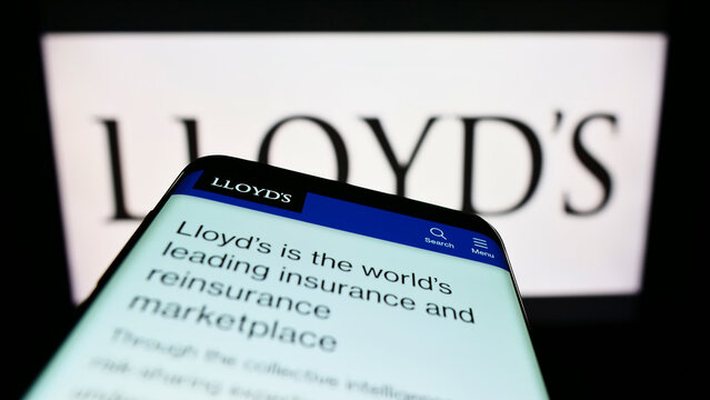 Stuttgart, Germany - 08-28-2022: Mobile phone with webpage of British insurance marketplace Lloyd's of London on screen in front of logo. Focus on top-left of phone display.