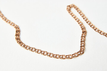 Gold chain on a white background with copy space