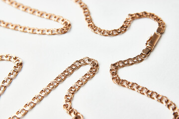 Gold chain on a white background with copy space