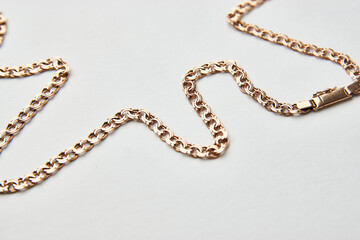 Gold chain on a white background with copy space