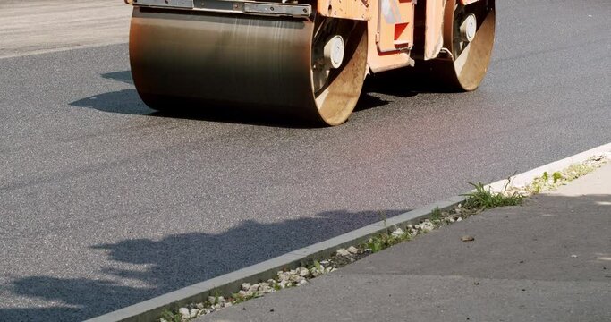 Asphalt paver machine on a road construction site. Road Paving on Residential Street. Road building asphalt paver is laying a new layer of asphalt, Asphalt Road Construction