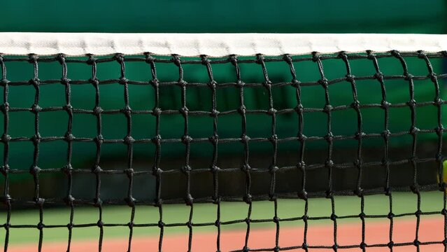 Super Slow Motion Shot of Tennis Ball Hitting the Net on Court at 1000fps.