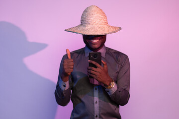 african man holding his phone, does thumbs up gesture