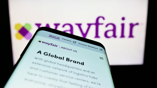 Stuttgart, Germany - 08-28-2022: Mobile phone with webpage of American e-commerce company Wayfair Inc. on screen in front of business logo. Focus on top-left of phone display.