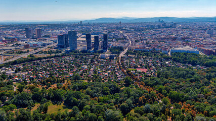 Vienna downtown district and urban skyline aerial view in Austria. Flying above green nature ft....