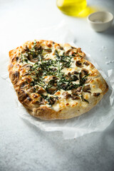 Homemade pizza with mushrooms and arugula