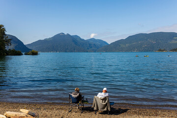 An elderly couple enjoy the sun and scenery at Lake Harrison