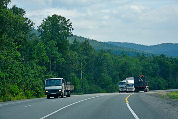 A high-speed road in the Ural Mountains in Russia. Cargo and passenger transport on the mountain road.