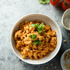 Homemade chicken ragout with pine nuts
