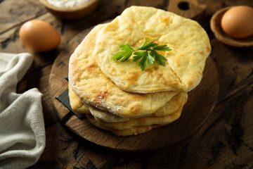 Traditional homemade flatbread on a wooden desk