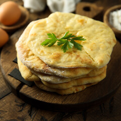 Traditional homemade flatbread on a wooden desk