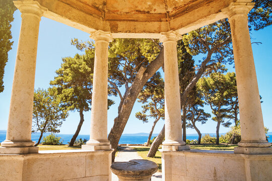 Coastal summer cityscape - view of the sea view from the gazebo with stone columns, park on the seashore in the city of Split, the Adriatic coast of Croatia