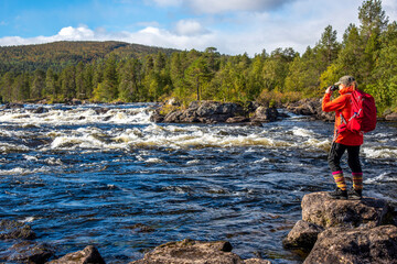 Obraz premium Woman hiking in forest in Finland Lapland