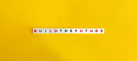 Build the Future Phrase on Block Letter Tiles on Yellow Background. Minimal Aesthetics.