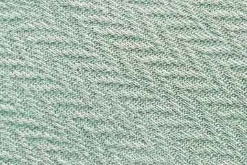 Green soft ornamental knitted pattern texture as background
