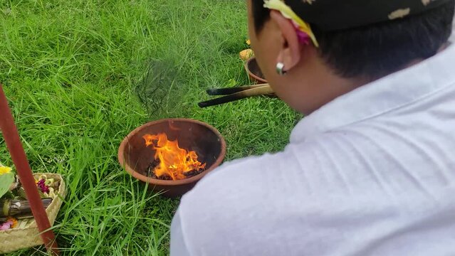 Ngaben or cremation ceremony in Bali, Indonesia. It is performed to release the soul of a dead person. The stage of burning the remaining bones in the Ngaben tradition.