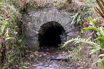Small arched tunnel used for water drainage