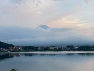 6pm, tip of Mt. Fuji&rsquo;s head started to peak behind the thick clouds, showing us bless and saying hello after days of cloudy weeks.  We were lucky. Year 2022 August 26th, Yamanashi Kawaguchiko Lake.