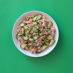 Creamy Dill Salmon Pasta Salad on a Green Background