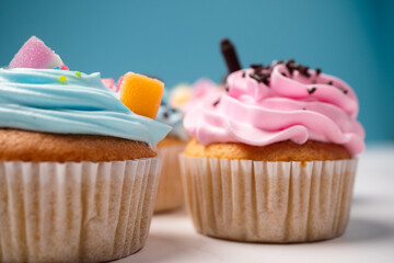 Delicious homemade cupcakes with Colorful cream and topping with candy and Chocolate Cookies. Homemade autumn holiday dessert
