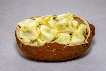 Ripe cupuaçu fruit (Theobroma grandiflorum) opened showing the seeds and the husk of the fruit. 
