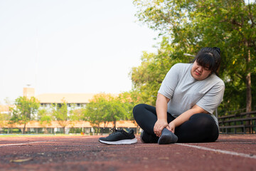 Asian overweight woman a new runner pain ankle during running, Athlete runner training accident. Sport running ankle sprained sprain cause injury. weight loss, workout, sports, health care concepts