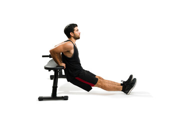 Young man with fitness lifestyle working out with tricep dips