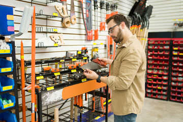 Carpenter at the hardware store shopping for new tools