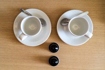 Obraz na płótnie Canvas Couple cups in saucers with coffee capsules