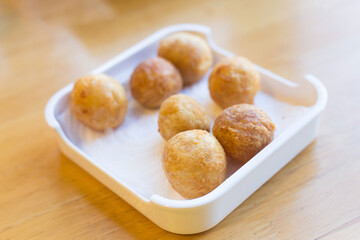 Fried premium shrimp ball made from fresh shrimp suitable to be served with noodles on a white plate. Selective focus with shallow depth of field on the top view. Delicious crispy shrimp balls.