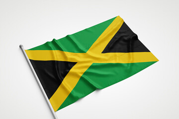 Jamaica Flag is Laying on a White Surface