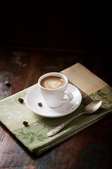 Cup of coffee on dark wooden background. Copy space.