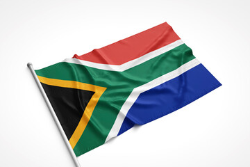 South Africa Flag is Laying on a White Surface
