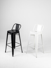 White and black bar chairs on white background