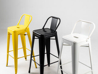 White, black and yellow bar chairs on white background