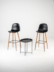 Black bar skin chairs with wood chair leg  and black table on white background