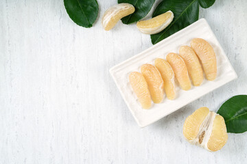 Fresh pomelo fruit on white table background.