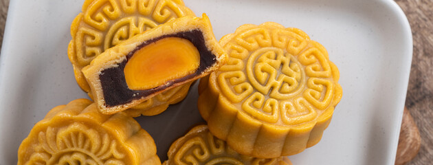 Delicious Cantonese moon cake for Mid-Autumn Festival food mooncake on wooden table background.