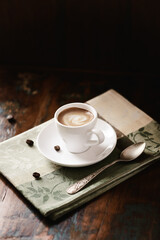 Cup of coffee on dark wooden background. Copy space.