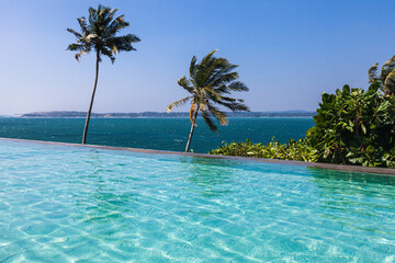 Beautiful turquoise pool overlooking the endless blue ocean